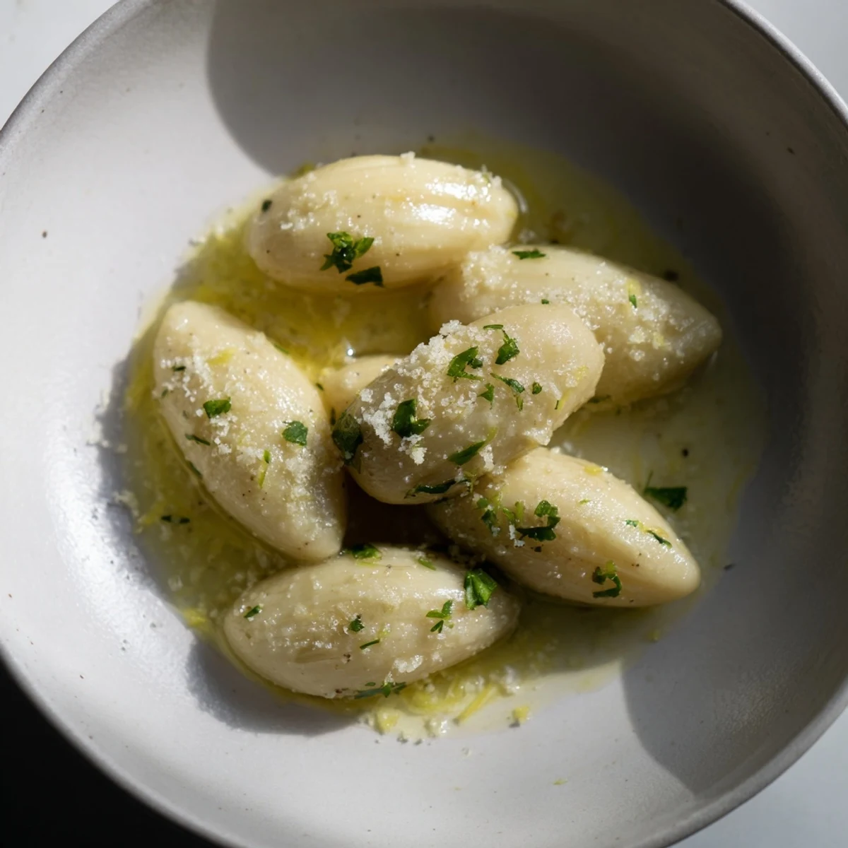 Glistening close-up of fresh garlic, blended with olive oil, ready for your next meal.