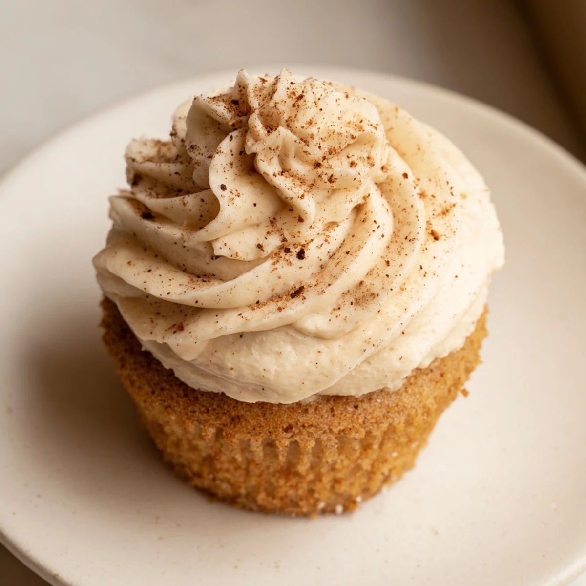A close-up of beautifully frosted Spiced Chai Latte Cupcakes, inviting you to taste those warm chai spices.
