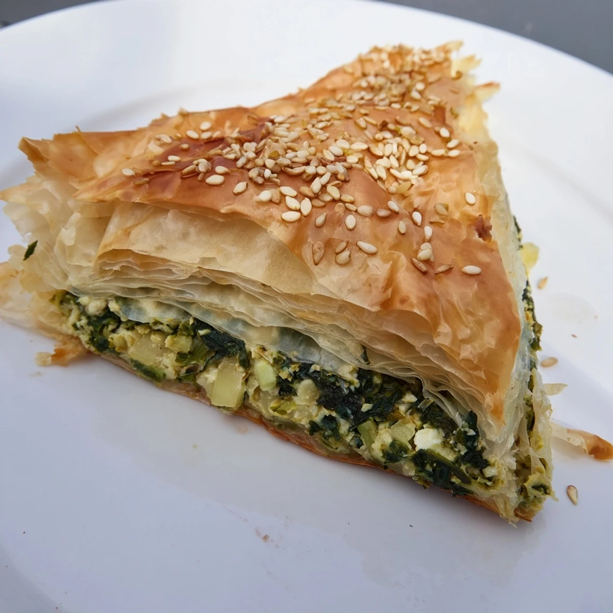 Golden, flaky Savory Spinach and Feta Pastries, boasting a savory, herb-filled aroma perfect for snacking.