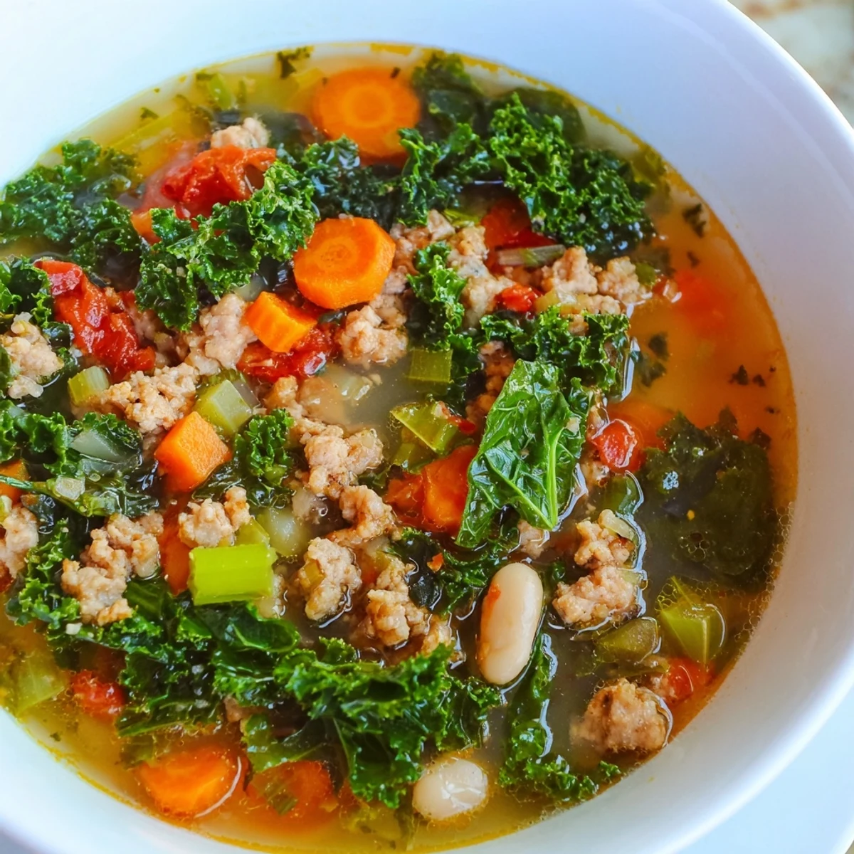 Steaming bowl of Turkey Sausage and Kale Soup, showing vibrant greens and hearty sausage pieces.