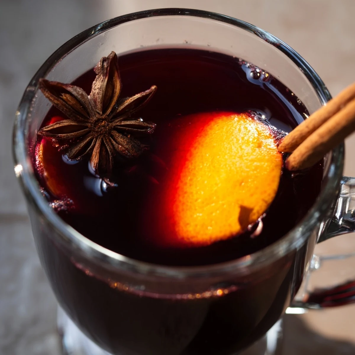 Cozy winter setup featuring Spiced Alcohol-Free Wine, a vegan warm drink served in a rustic ceramic mug.