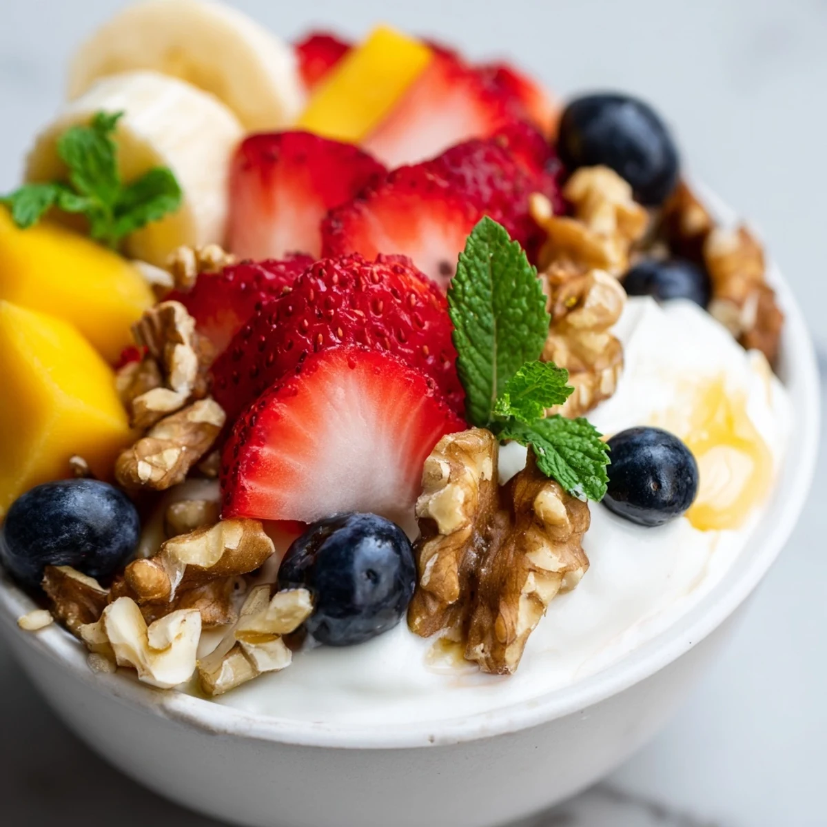 A spoonful of Creamy Yogurt with Fruit showing thick Greek yogurt, honey drizzle, and crunchy granola toppings.