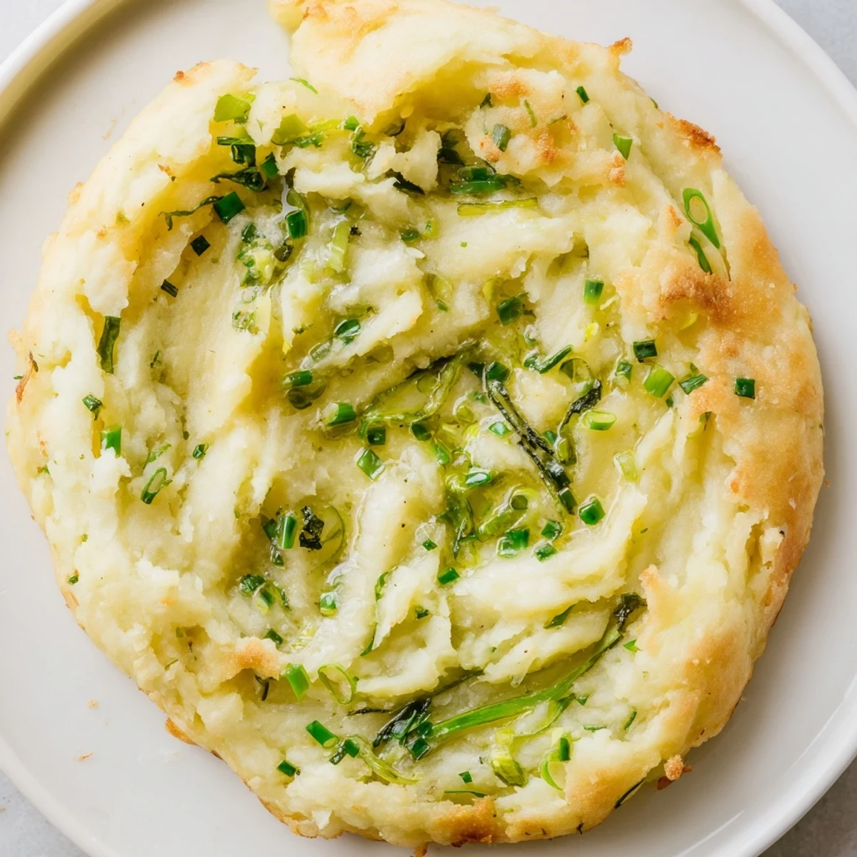 Fluffy Irish Potato Cakes with Scallions served warm with a pat of melting butter.  