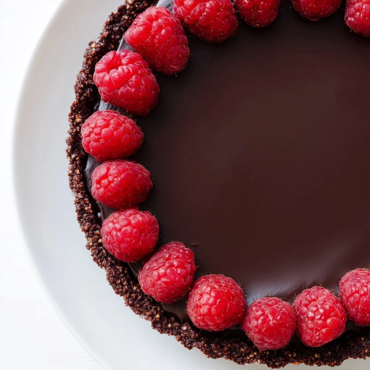 A crisp, homemade chocolate crust holds a rich ganache, topped with fresh raspberries for the Chocolate Raspberry Tart with Ganache.