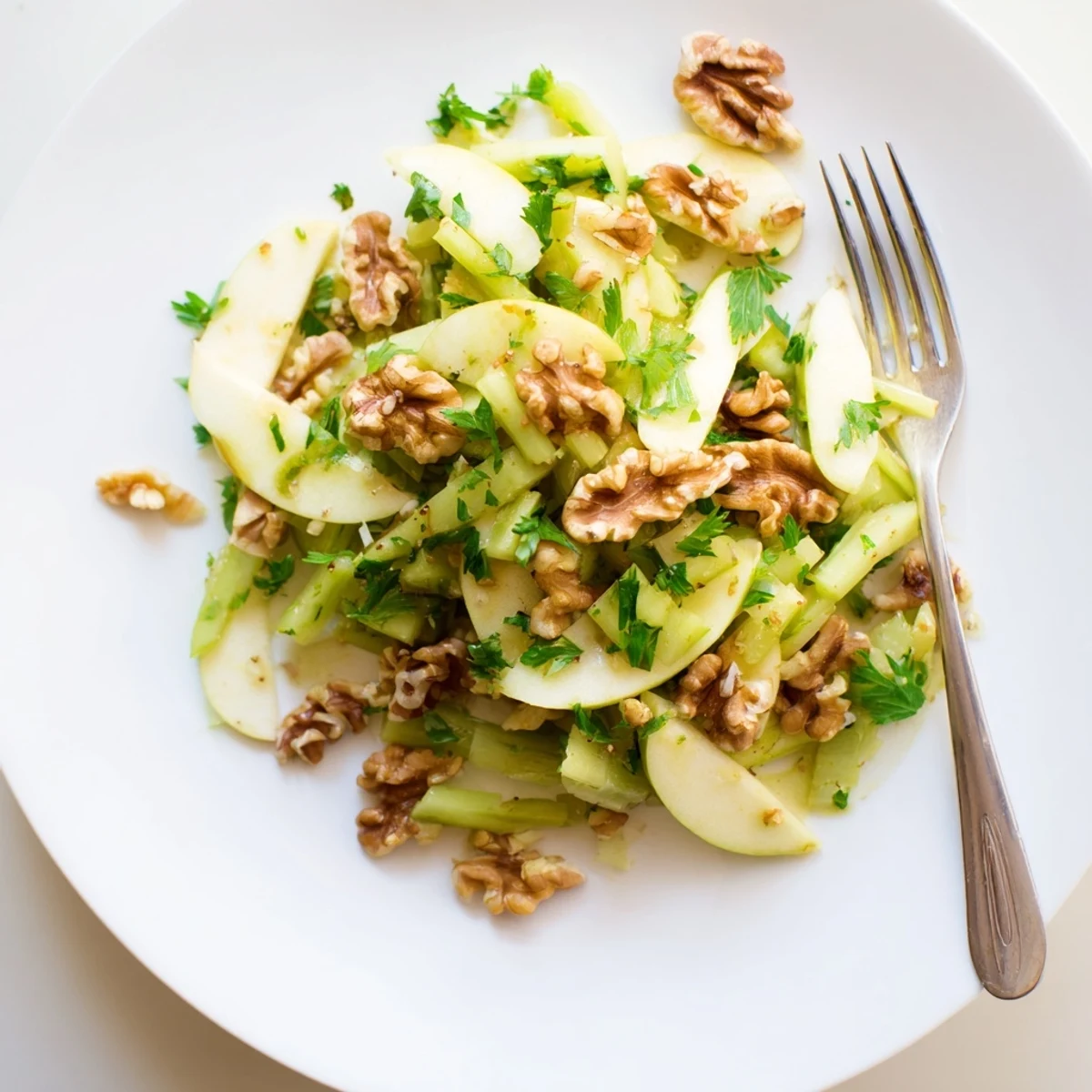 Freshly sliced apples, celery, and toasted walnuts tossed in a tangy honey-Dijon dressing for this Apple and Celery Salad with Walnuts.