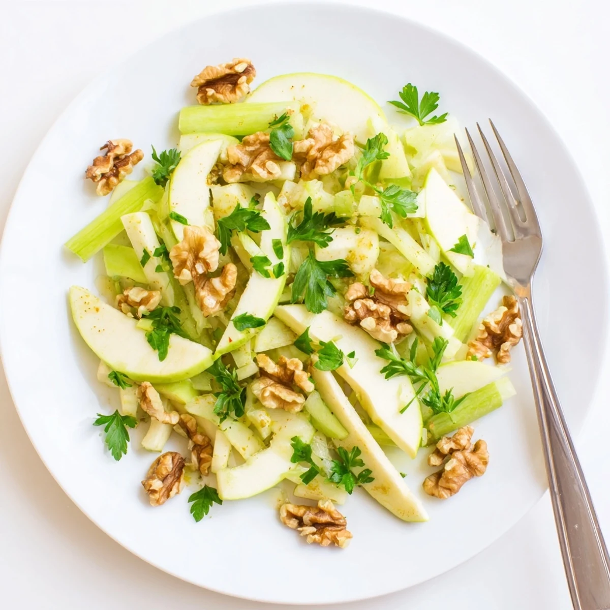 Refreshing Apple and Celery Salad with Walnuts served on a rustic plate, highlighting the bright lemon dressing and crunchy textures.