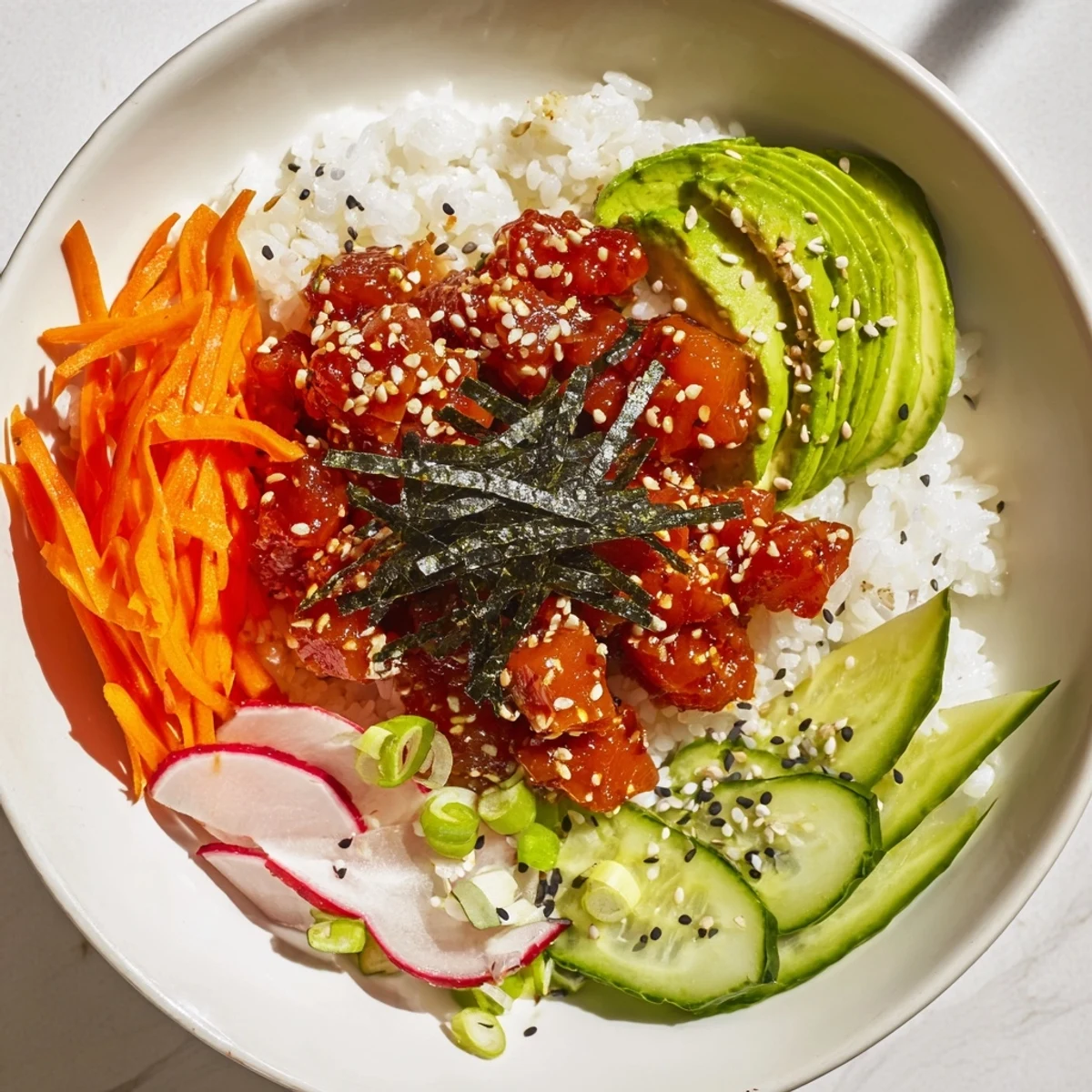 Serving suggestion for Spicy Tuna Poke Bowl garnished with scallions and nori strips, perfect for a healthy lunch.