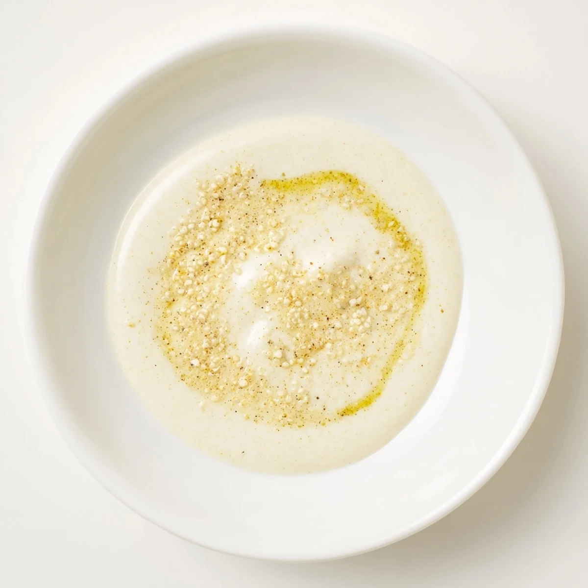 Close-up of creamy Lemon Dijon Dressing drizzled over a crisp garden salad with herbs.  