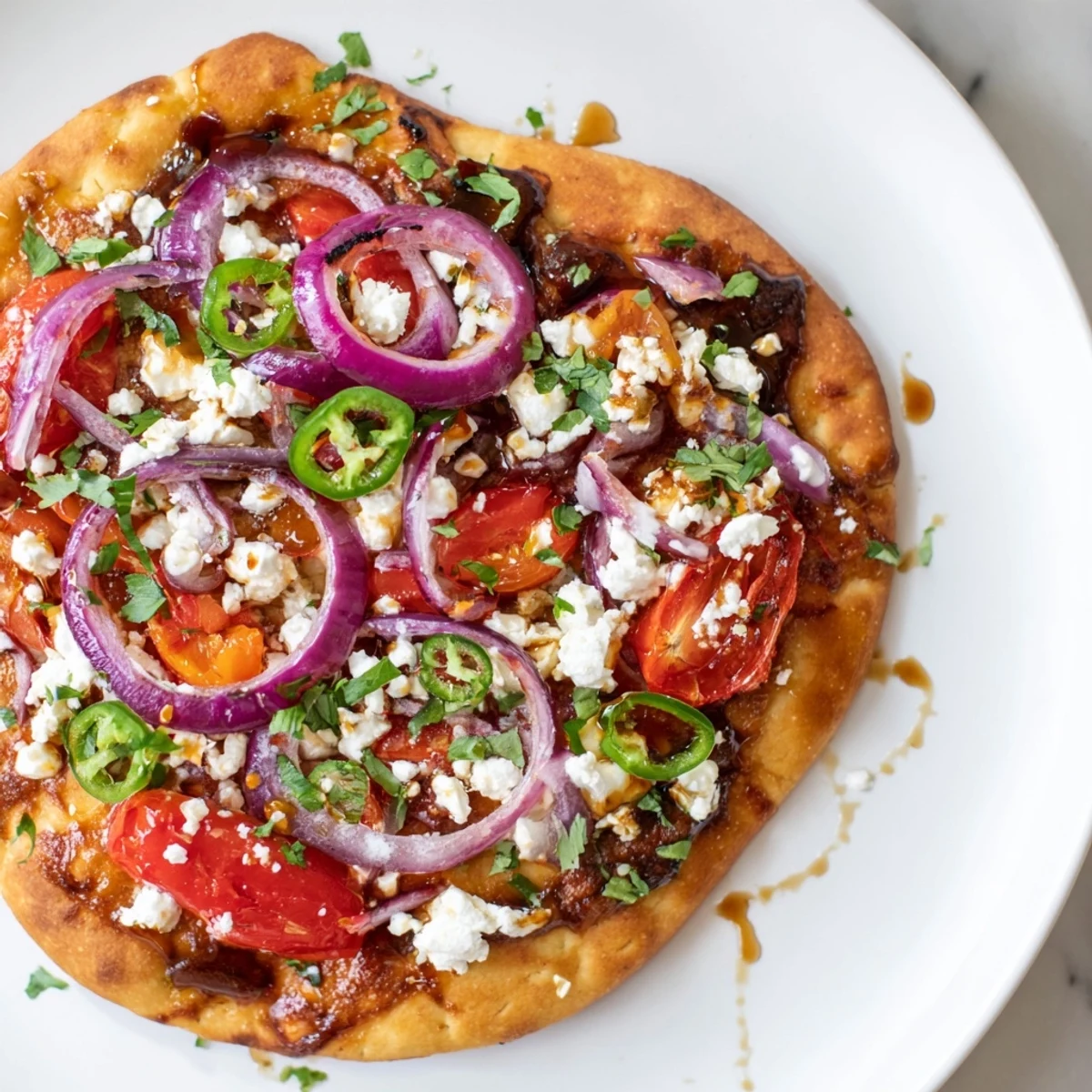 Fresh cilantro and sliced bell peppers top this easy homemade Sweet Heat Honey Garlic Flatbread Pizza.
