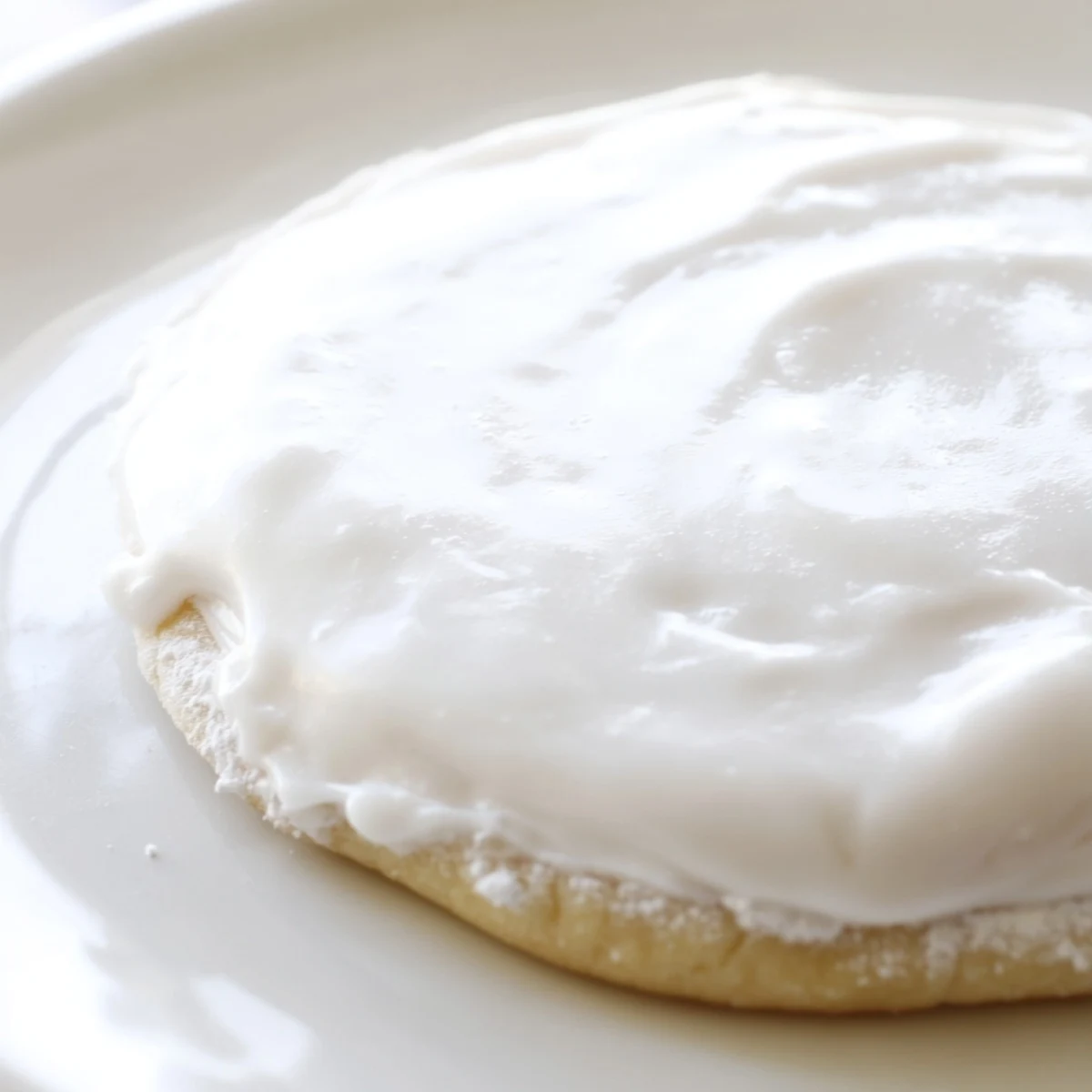 Glossy Sugar Cookie Icing drips smoothly over decorated cookies, ready for colorful sprinkles and celebrations.