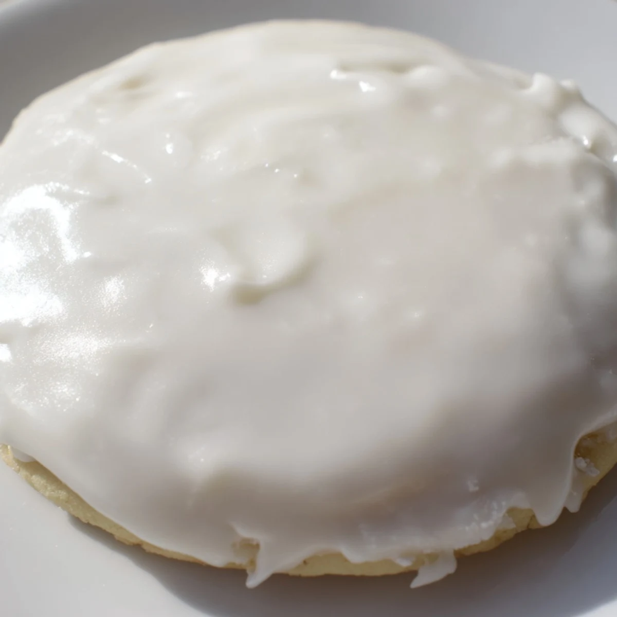Sugar Cookie Icing is being applied with a piping bag to cooled cookies for a festive look.