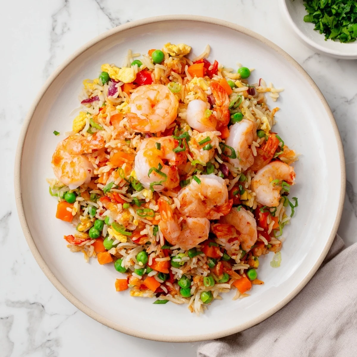 Golden garlic prawns atop colorful sweet chilli fried rice with crisp vegetables and scrambled eggs