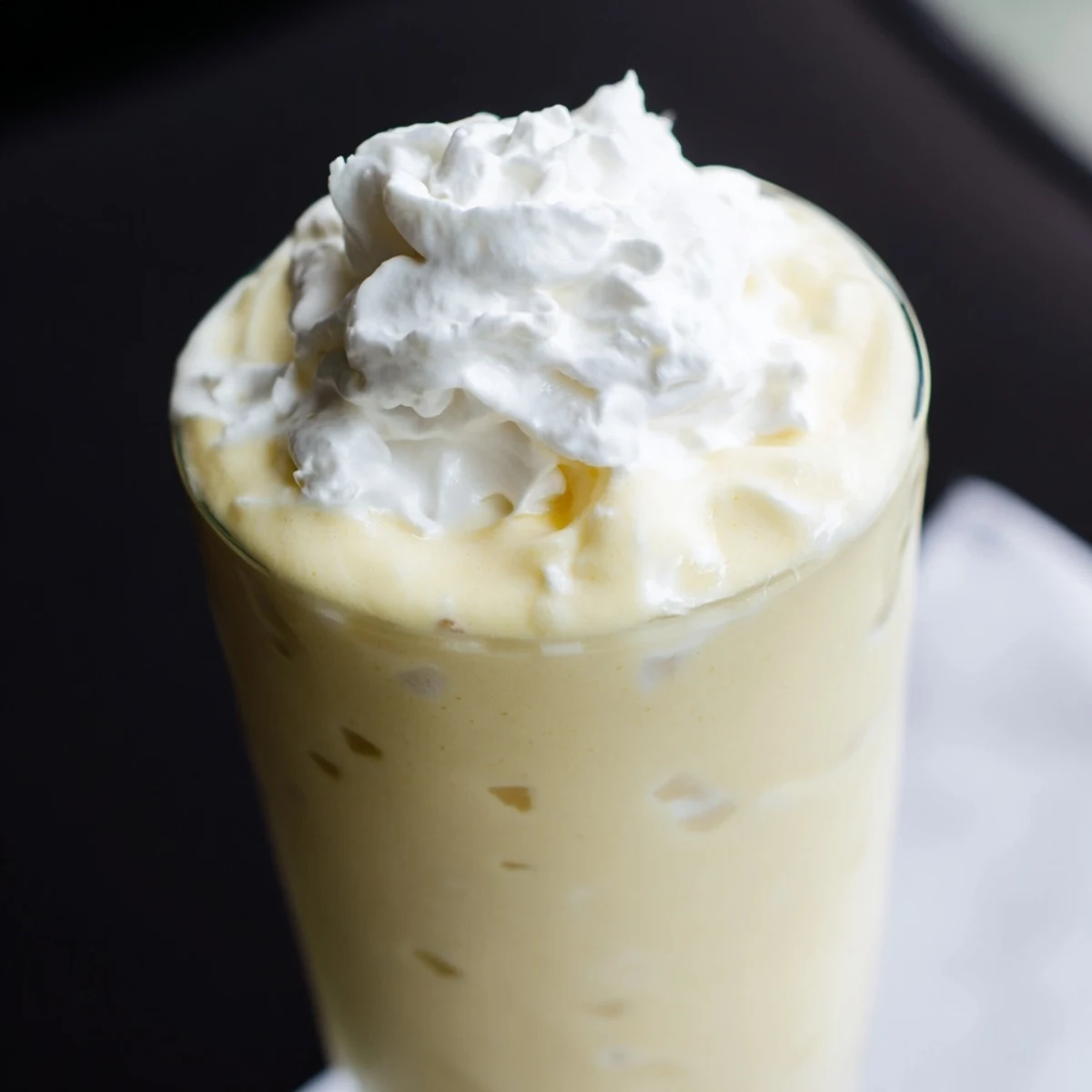 Vibrant glass of durian smoothie made with creamy coconut milk and fresh banana slices