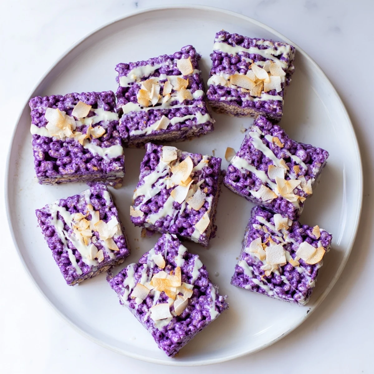Purple yam marshmallow bars with crispy rice cereal topped with melted white chocolate swirls