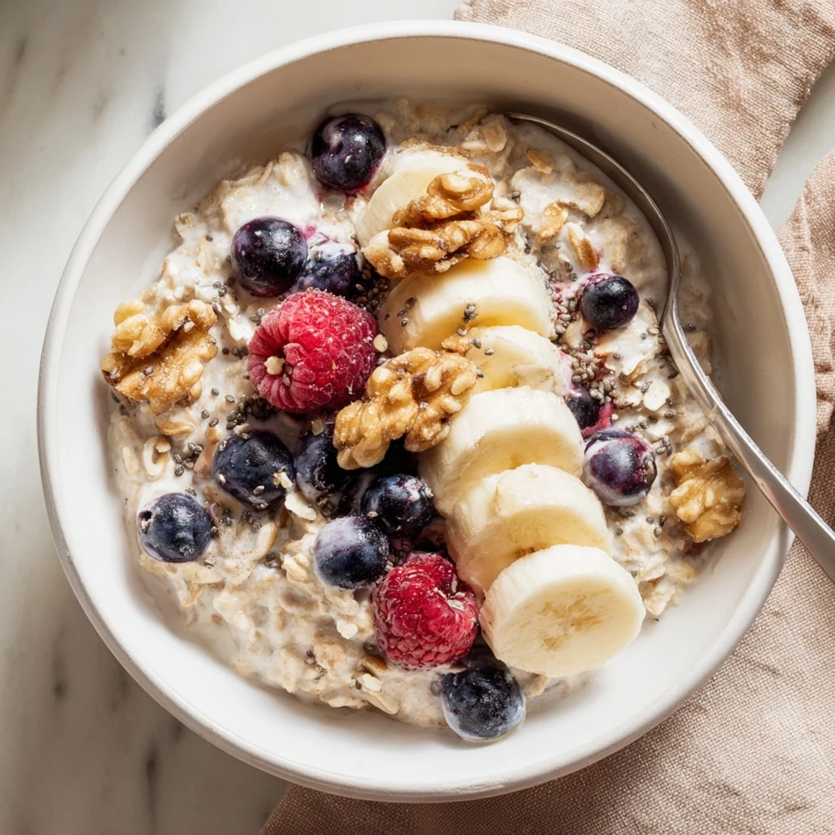 Wholesome brown sugar overnight oats layered with Greek yogurt, vanilla, and colorful fruit for breakfast