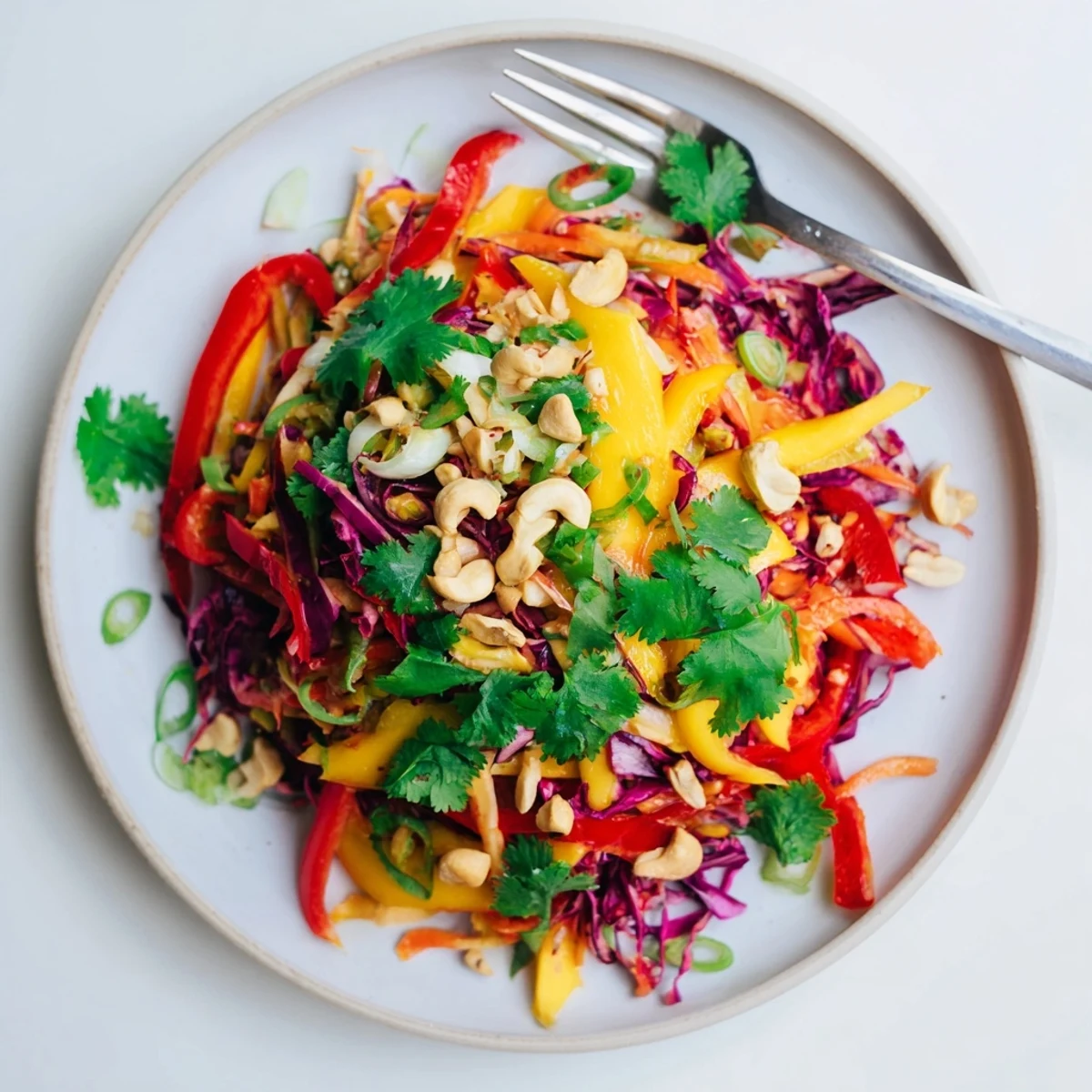 Colorful mango slaw with crisp red cabbage and carrots in lime dressing
