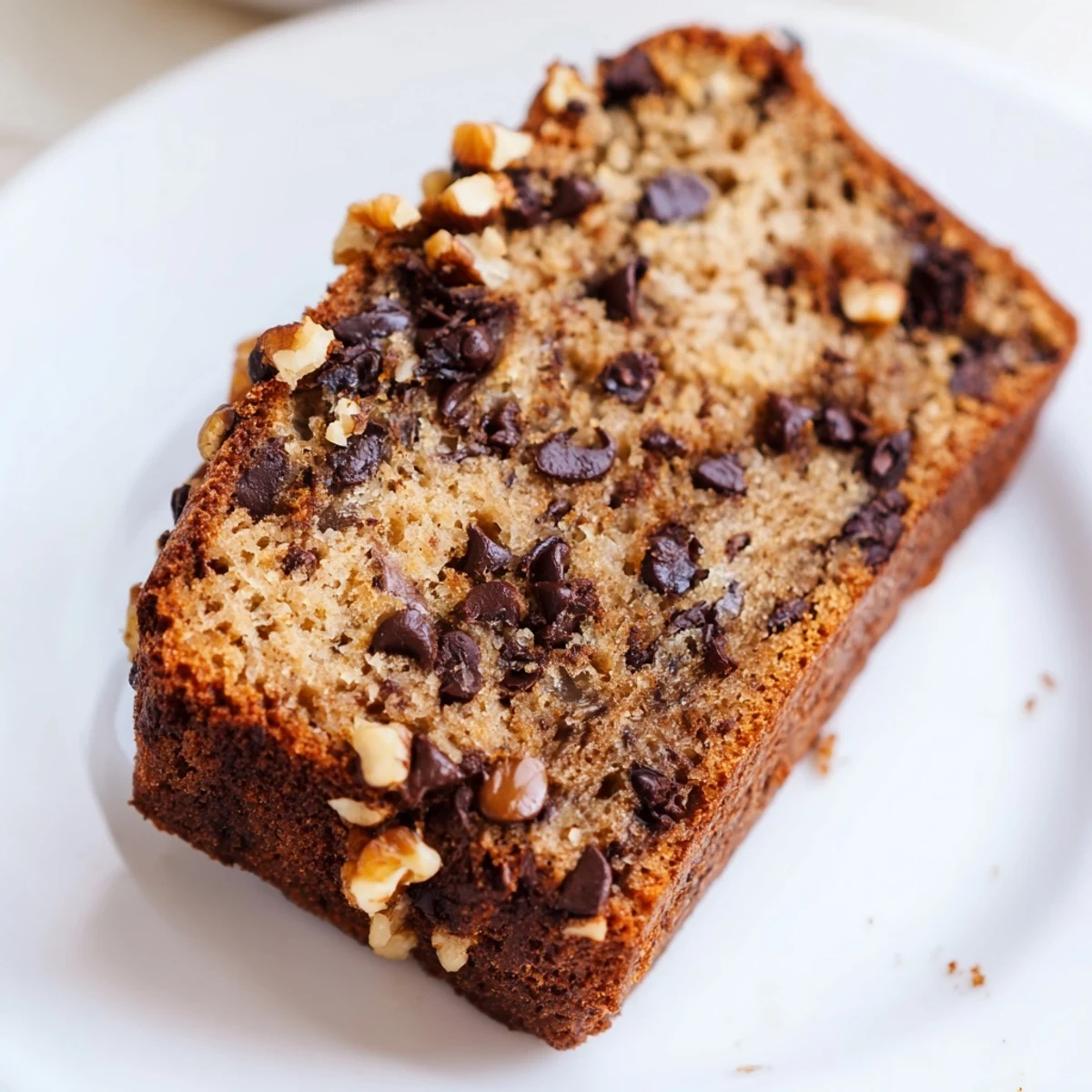 Freshly baked chocolate chip banana bread cooling on wire rack with golden crust