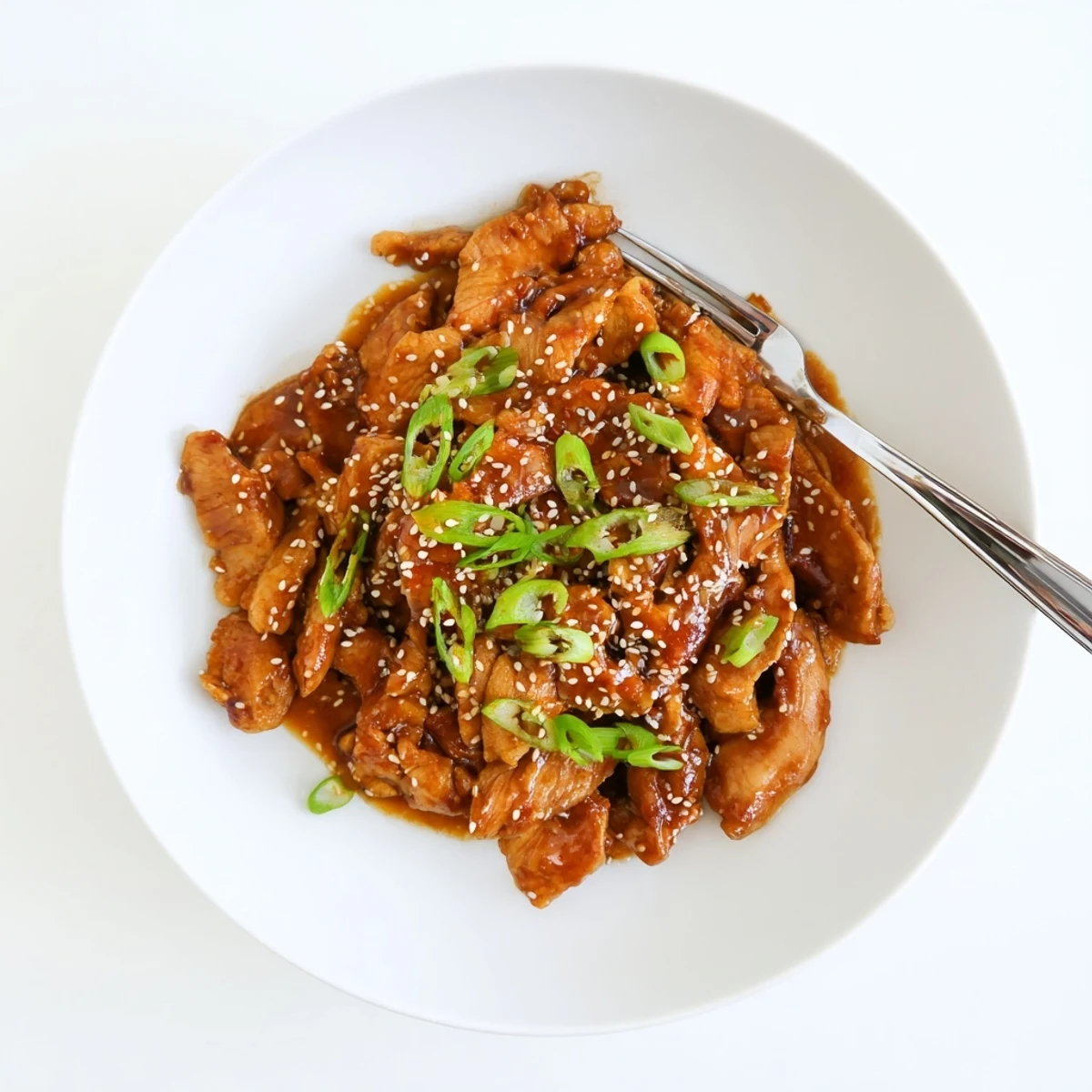 Easy slow-cooked teriyaki chicken served over steamed rice with caramelized sauce coating