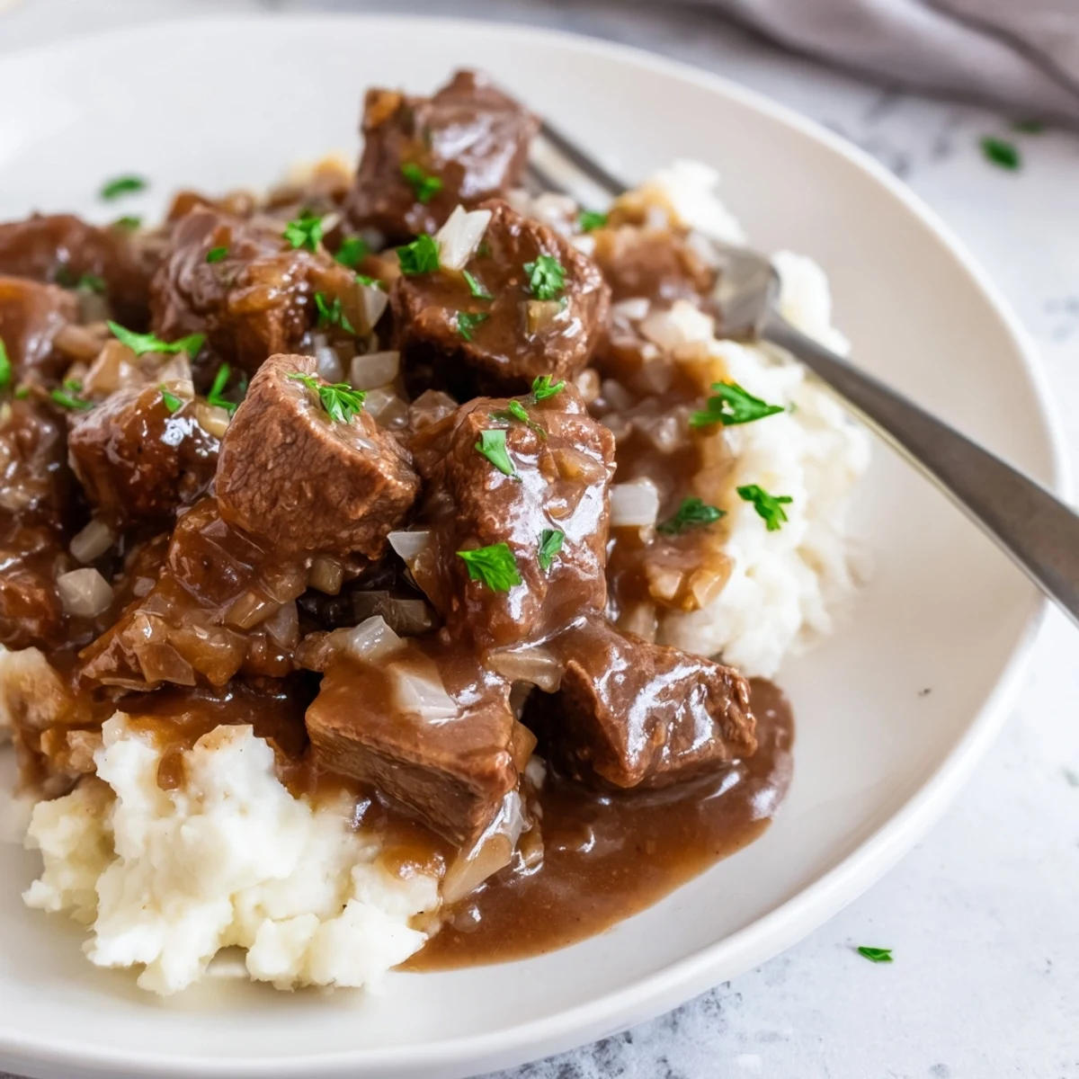 Rich savory gravy coats fork-tender beef tips in this comforting slow cooker beef tips and gravy dinner