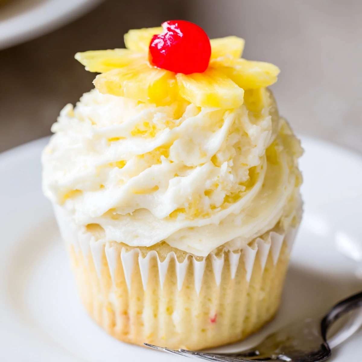 Dole Whip Cupcakes Recipe served on a cooling rack, garnished with cherries