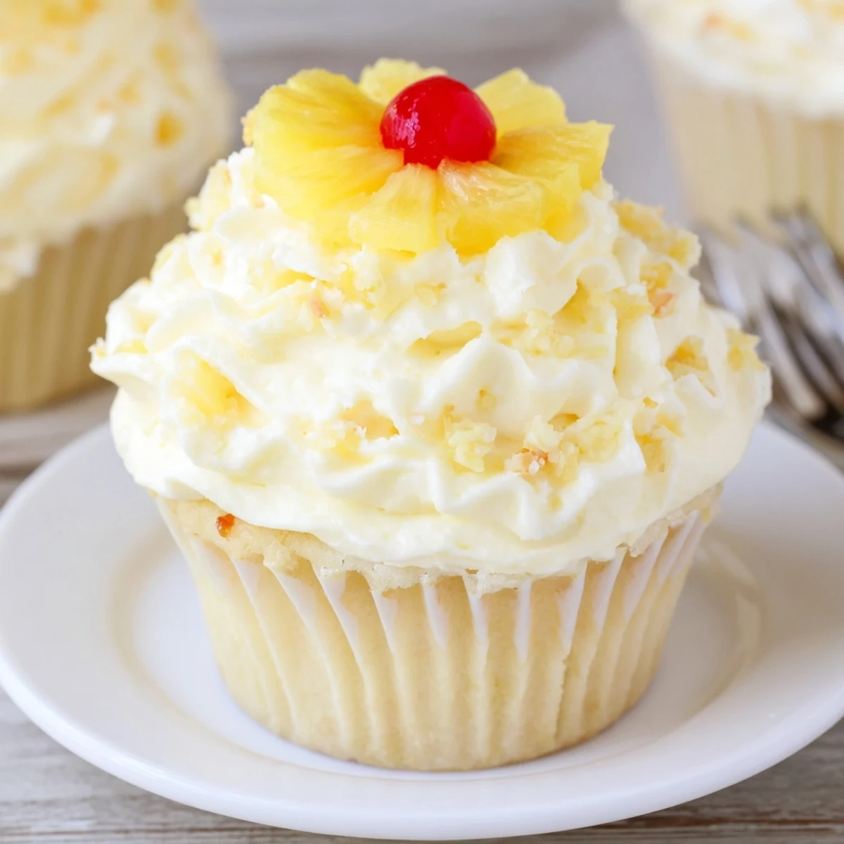 Soft pineapple cake topped with fluffy frosting — Dole Whip Cupcakes Recipe