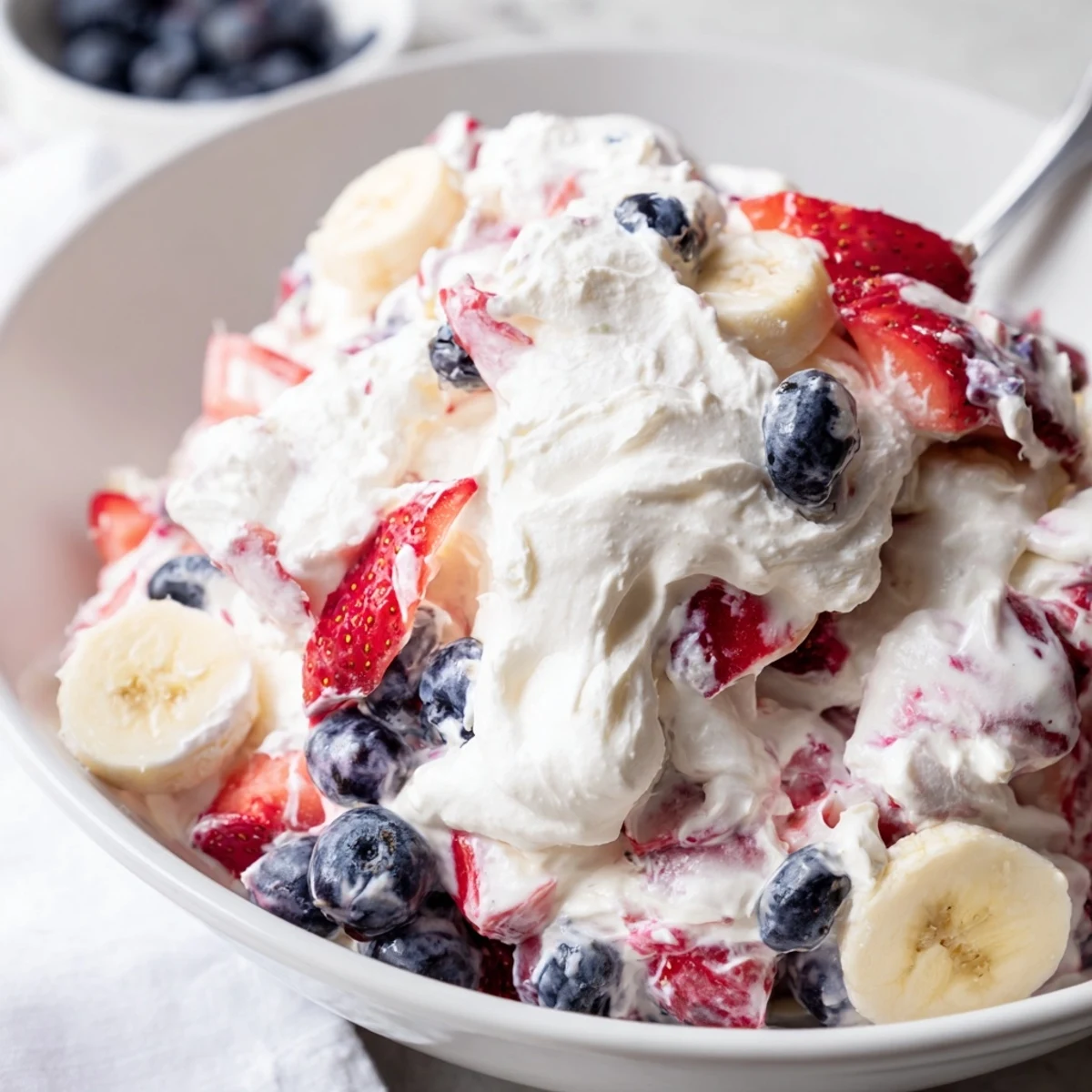 Red White And Blue Cheesecake Salad with creamy filling and juicy berries chilled
