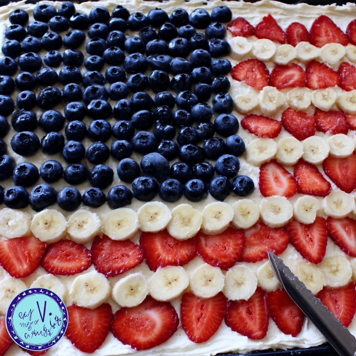 A festive American Flag Fruit Pizza arranged like a flag, perfect for picnics.