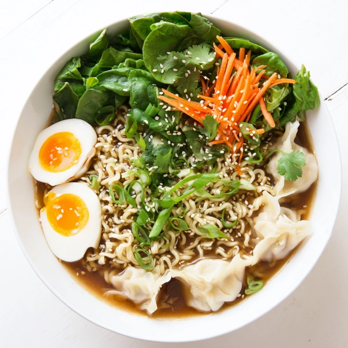 Homemade dumpling ramen with golden soft-boiled eggs, fresh cilantro, and sesame seeds in aromatic miso broth