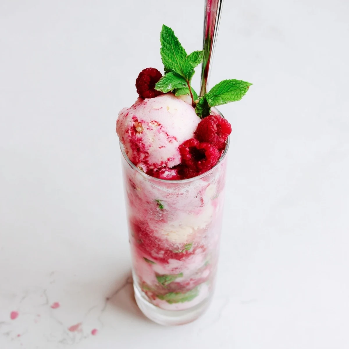Refreshing raspberry mint mojito rebel float with muddled berries, fresh mint garnish, and creamy scoops
