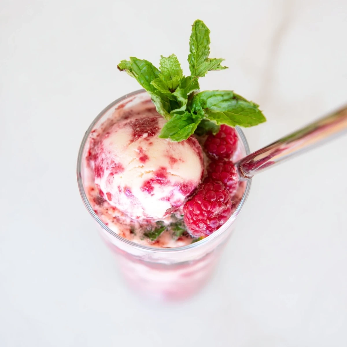 Summer raspberry mint mojito rebel float featuring fizzy soda, crushed raspberries, and vanilla ice cream swirl