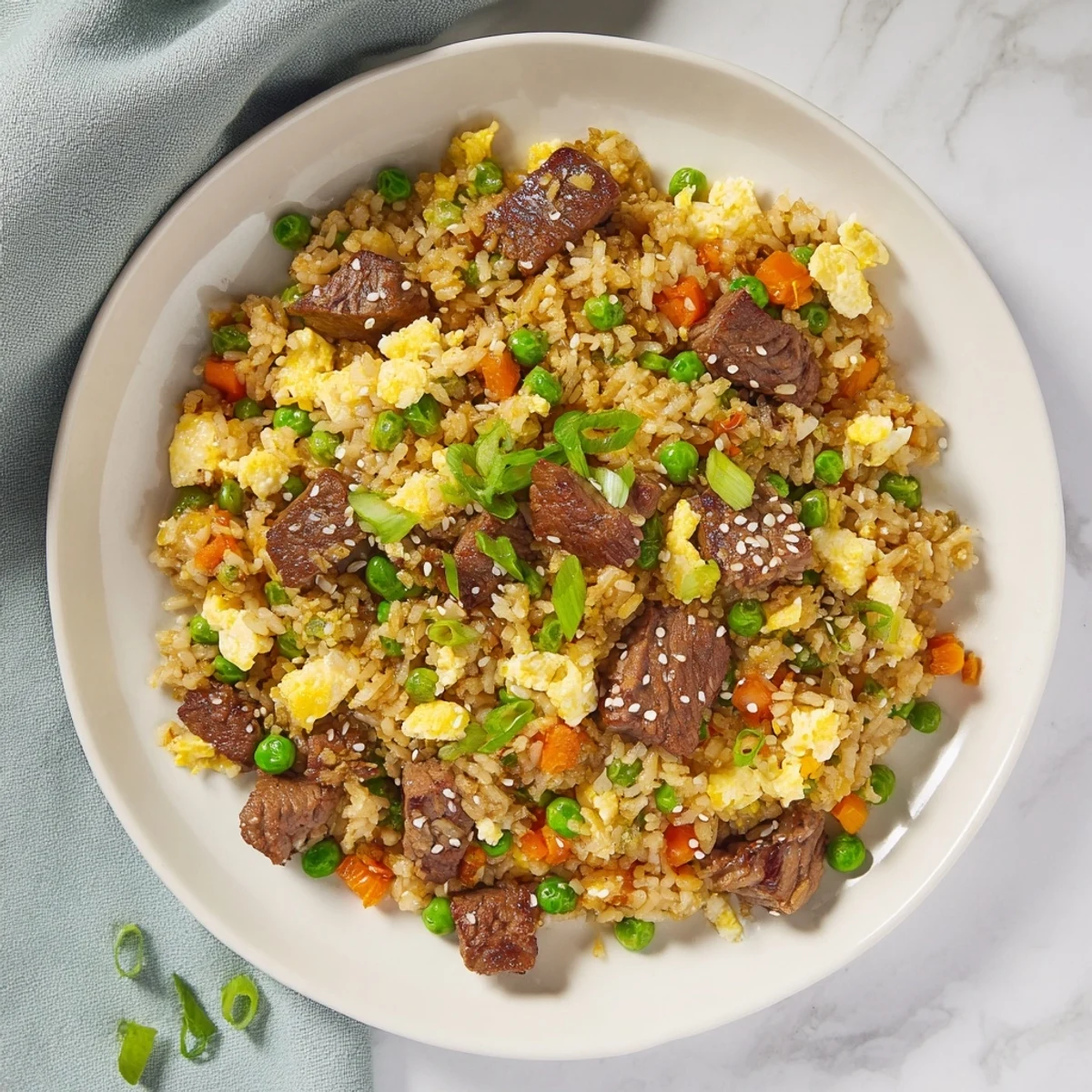 Sizzling Blackstone hibachi steak fried rice loaded with tender beef, colorful vegetables, and savory Japanese flavors