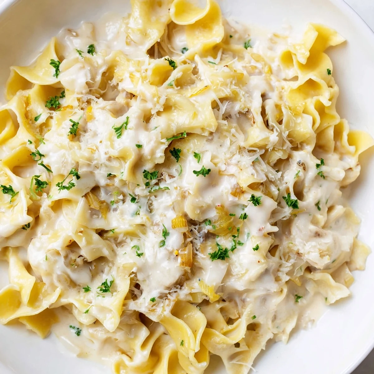 Comforting bowl of creamy cafeteria noodles with tender pasta in a smooth garlic cheese sauce