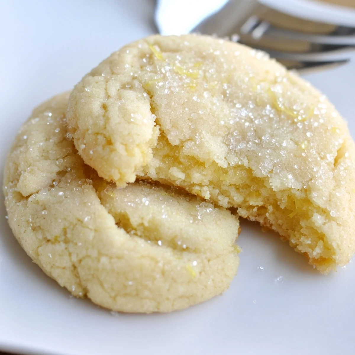 Warm plate of Soft Chewy Lemon Cookies, zesty aroma and tender centers.