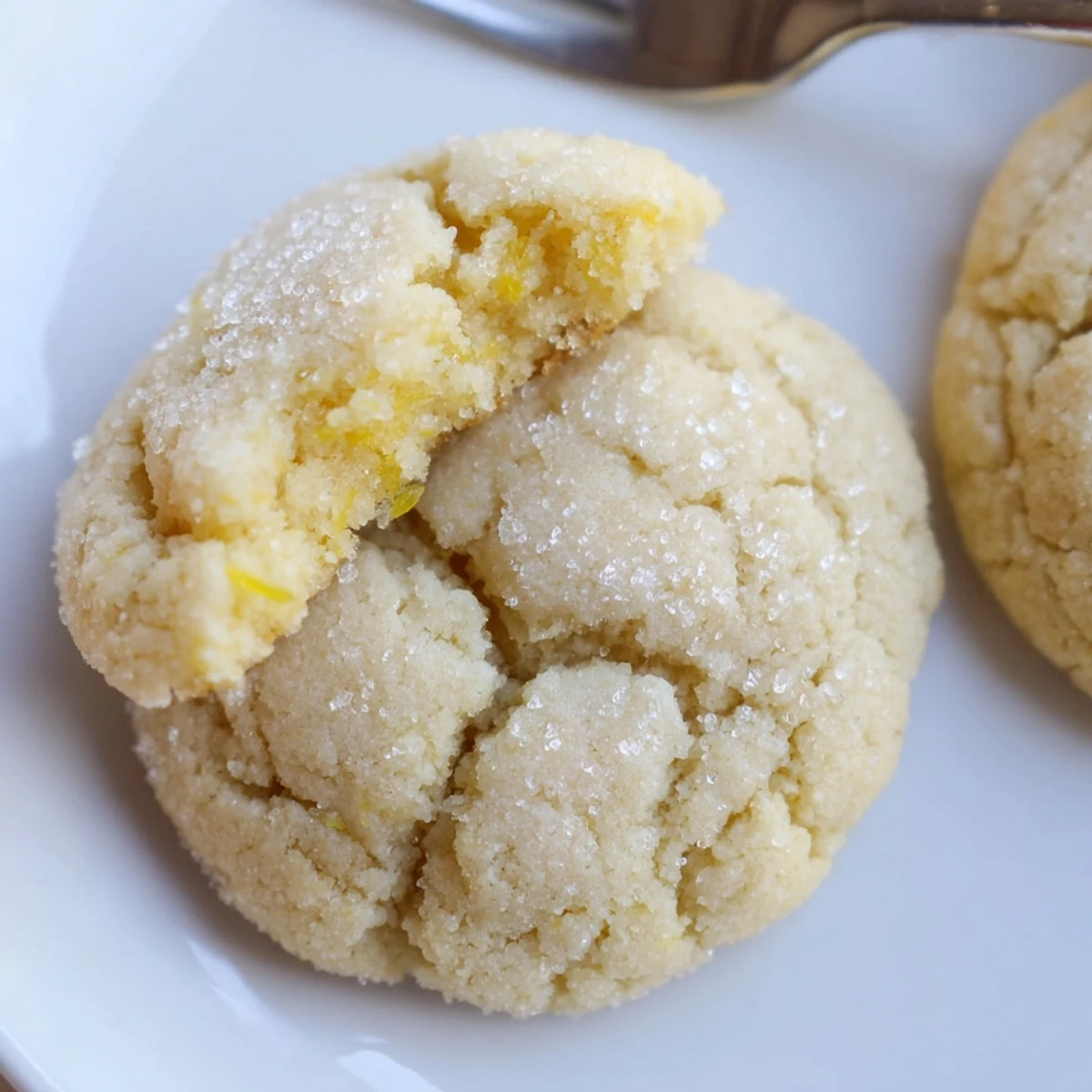 Fresh baked Soft Chewy Lemon Cookies cooling on rack, sugar crisp edges.