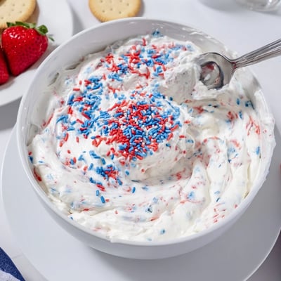 Chilled Red White And Blue Funfetti Dip served with vanilla wafers and strawberries  